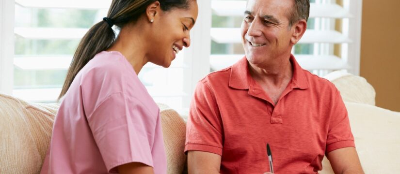 Middle-aged fit man with knee arthritis asks nurse about better treatments available in clinical trials.